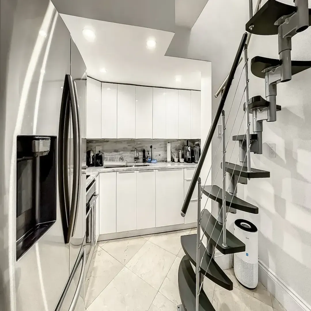 Modern kitchen at Villa Laurell Estate featuring stainless steel appliances, induction cooktop, convection oven, Nespresso coffee maker, and blender.