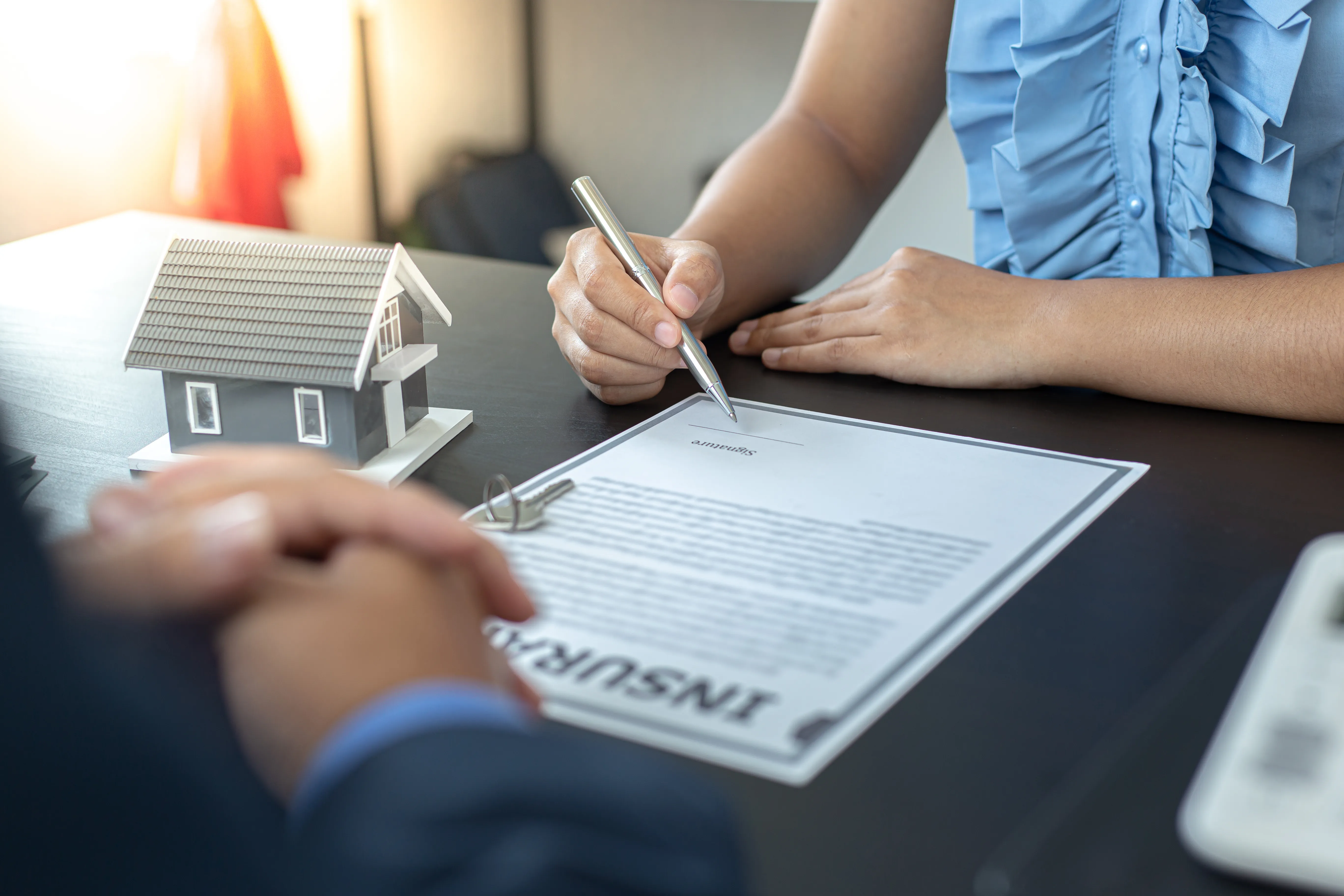 Insurance sales person closing an insurance contract with a client