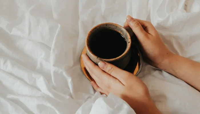 A cup of coffee in bed before the school morning routine starts.