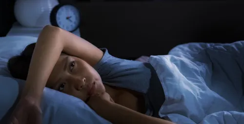 woman in bed wide awake