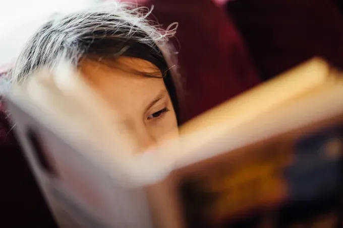 little girl reading a book