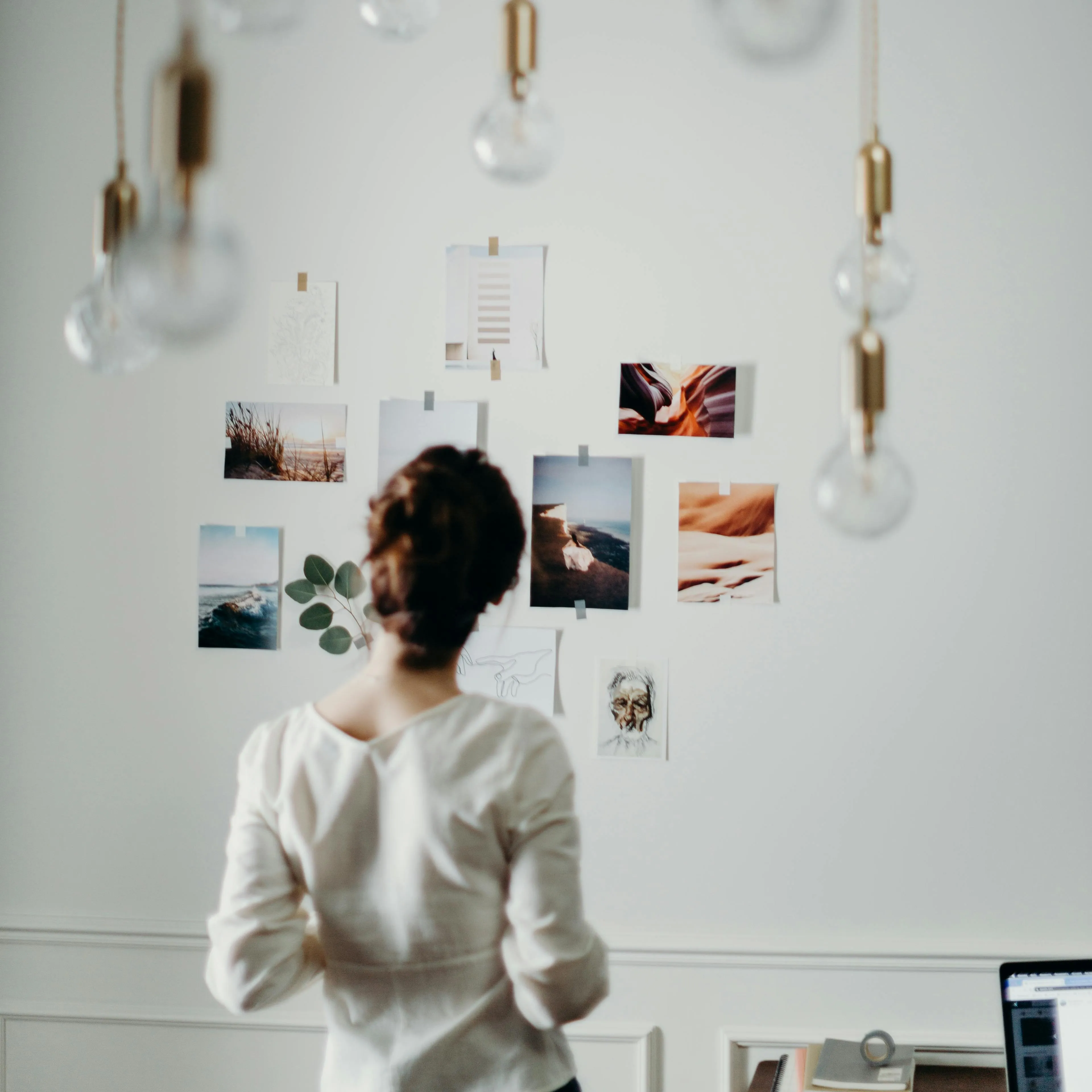 Woman looking at photo's on a wall