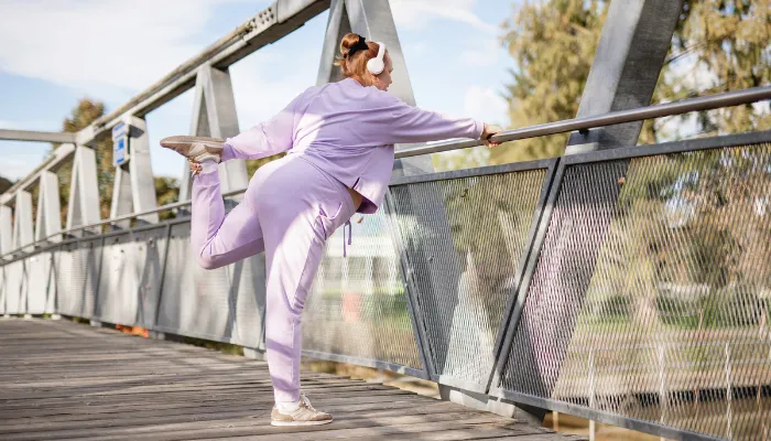 A woman working out on a bridge.