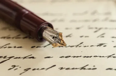handwritten letters using a quill pen