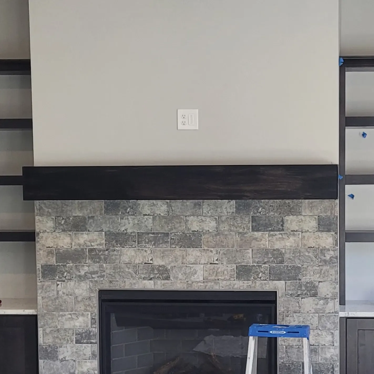 Custom wood mantel and shelving in a living room 