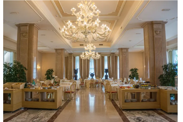 Luxurious event setup with exquisite decor, chandeliers, and elegant table settings