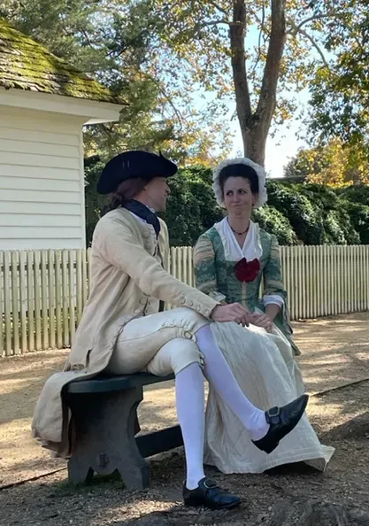 Daniel Cross portraying Colonel George Washington seated with Martha Washington