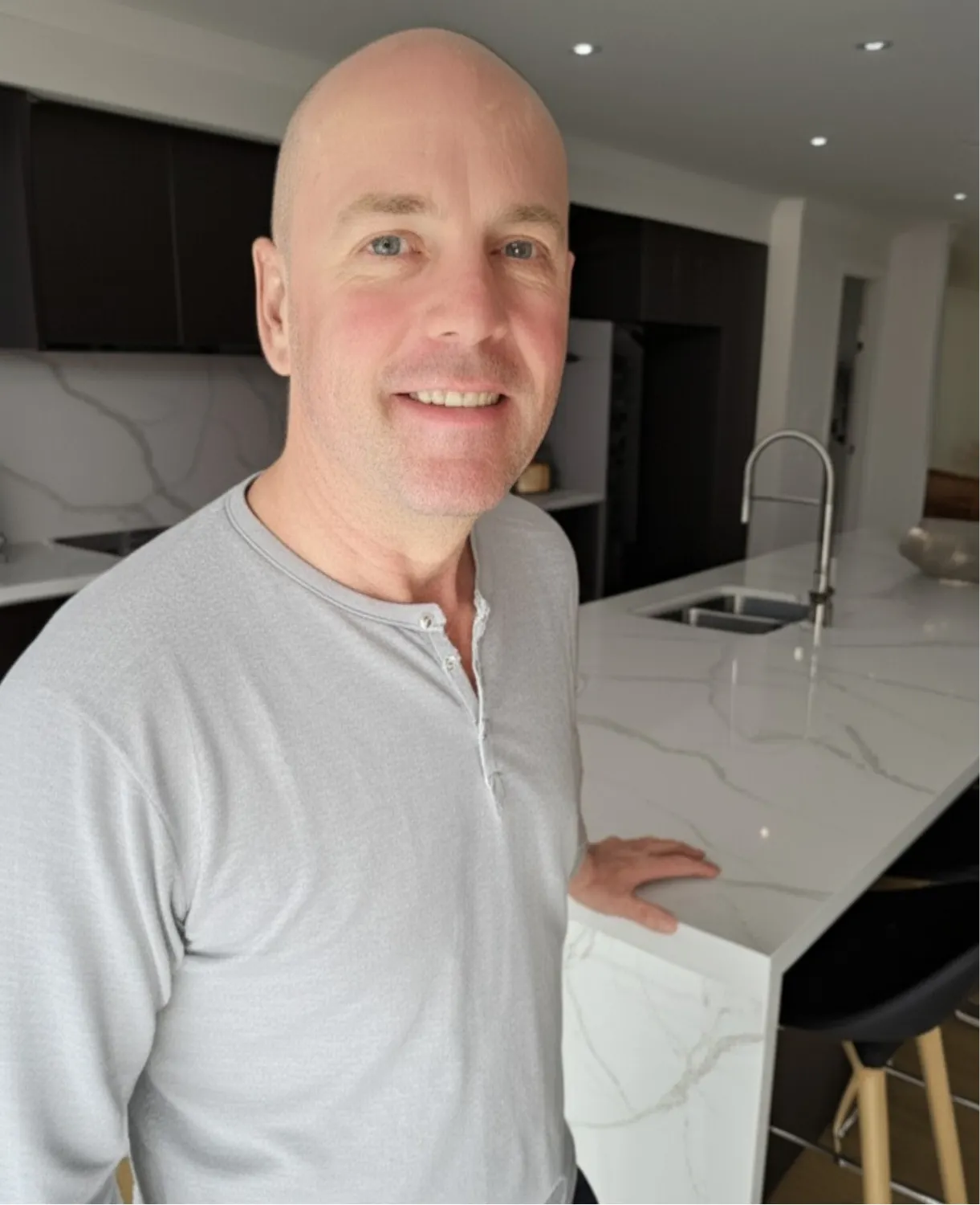 Founder, Luke standing at the kitchen of a newly built home