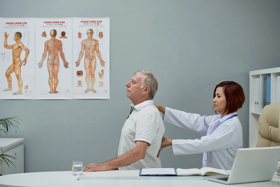 Chiropractor checking mans spine