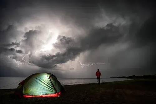 Matthew Storer setting up his camping shelter and sleep system on a multi-day hike