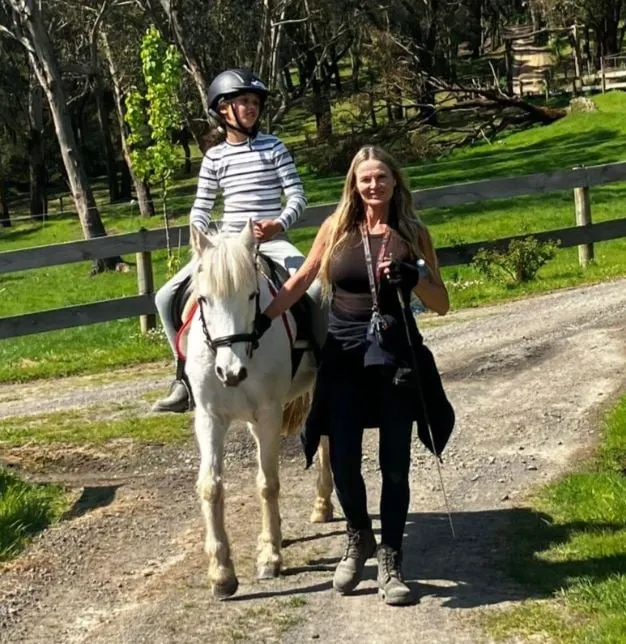 Our coach Renee out on the trail with school pony, Roxie and rider.