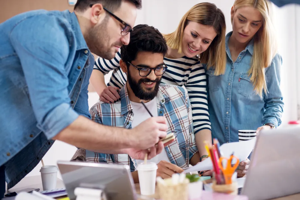 happy team around a computer