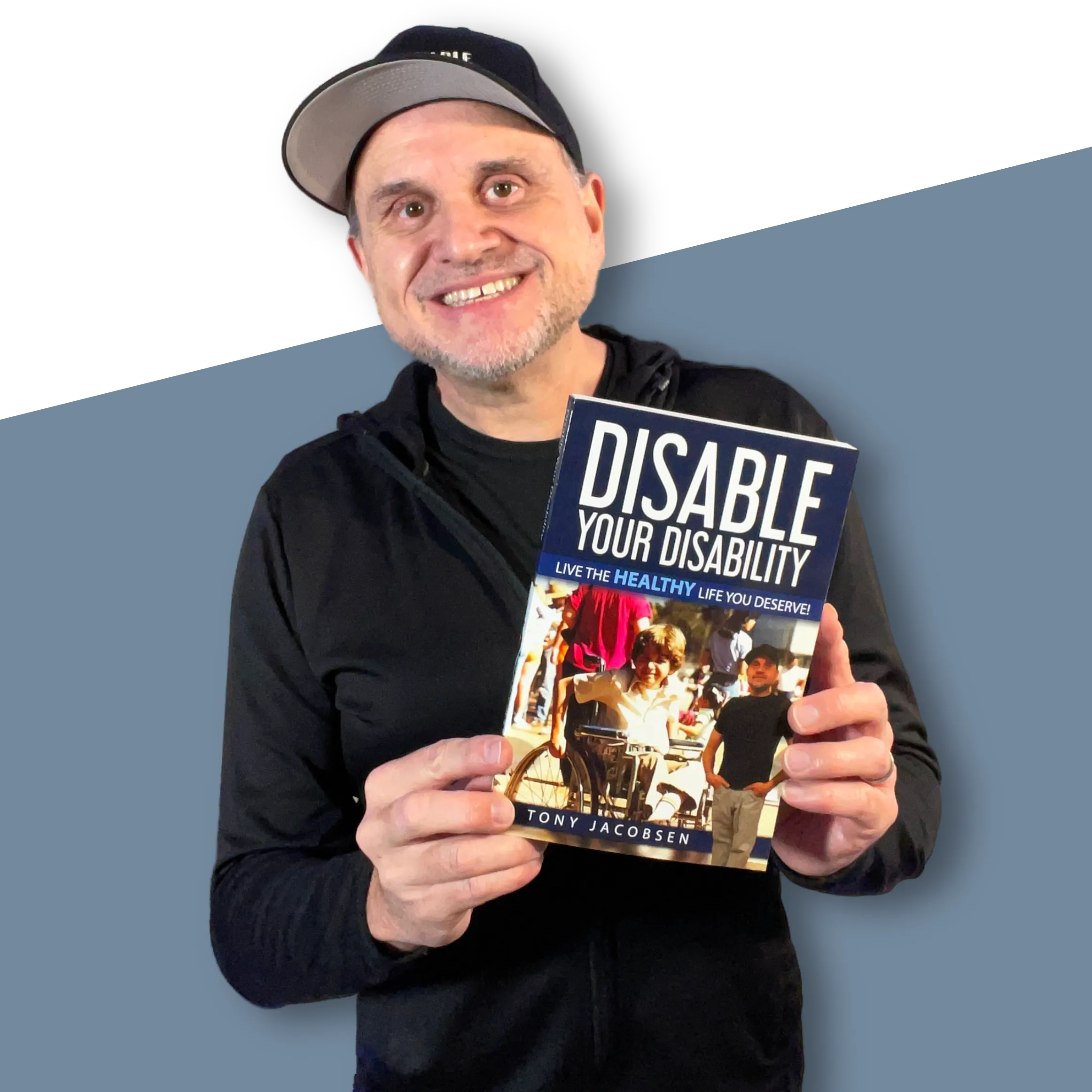 Tony Jacobsen displaying his book Disable Your Disability
