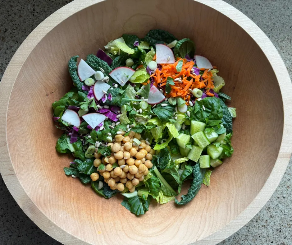 Lemon Herb Chickpea Crunch Bowl with romaine, cabbage, radishes, cucumbers, chickpeas, sunflower seeds, and creamy lemon herb dressing.