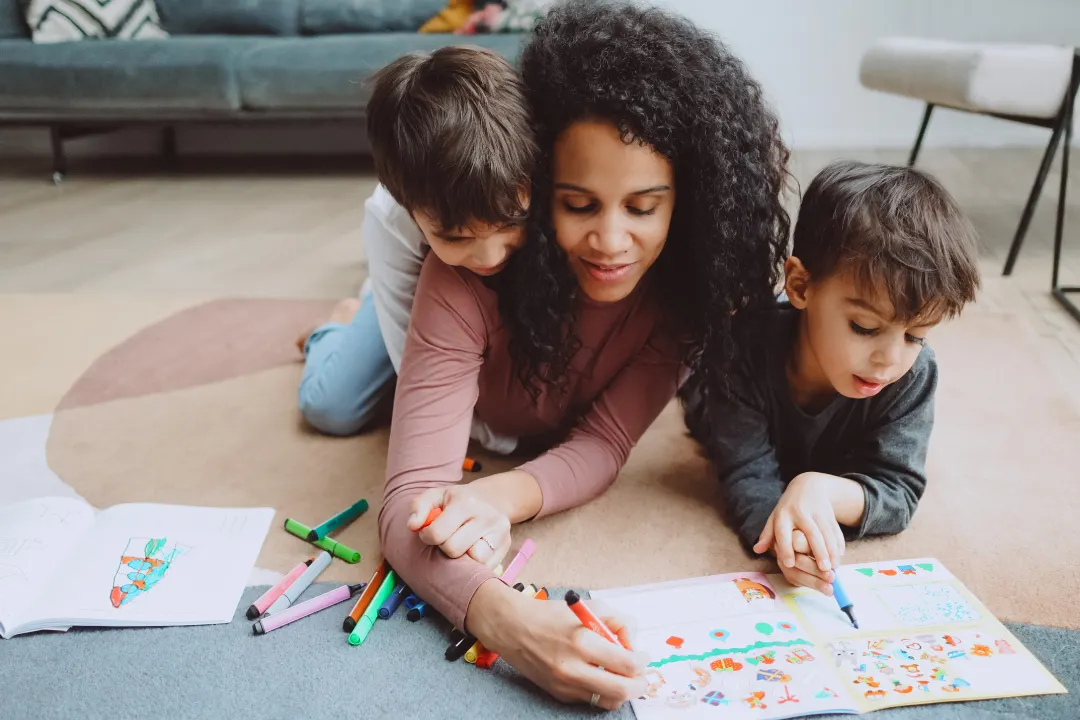 Woman colouring in with her children