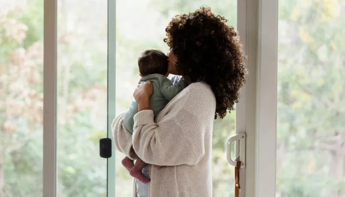 A young mom holding her baby.