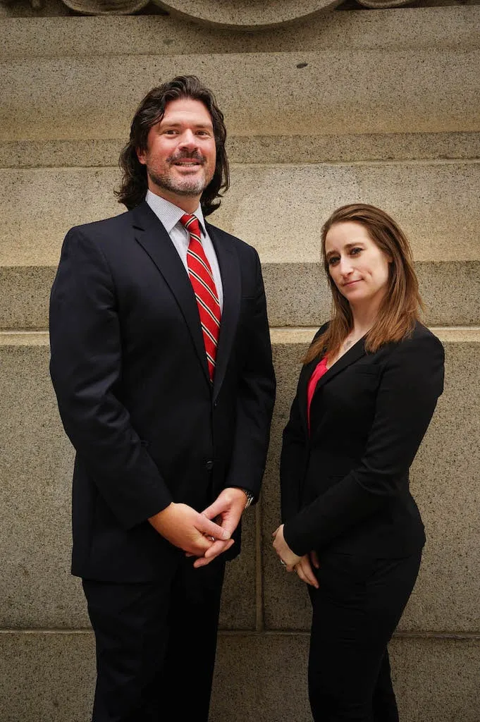 Aaron Shapiro and Amanda Shaffer of the Shapiro Law Firm, LLC posing in the New York City Financial District.