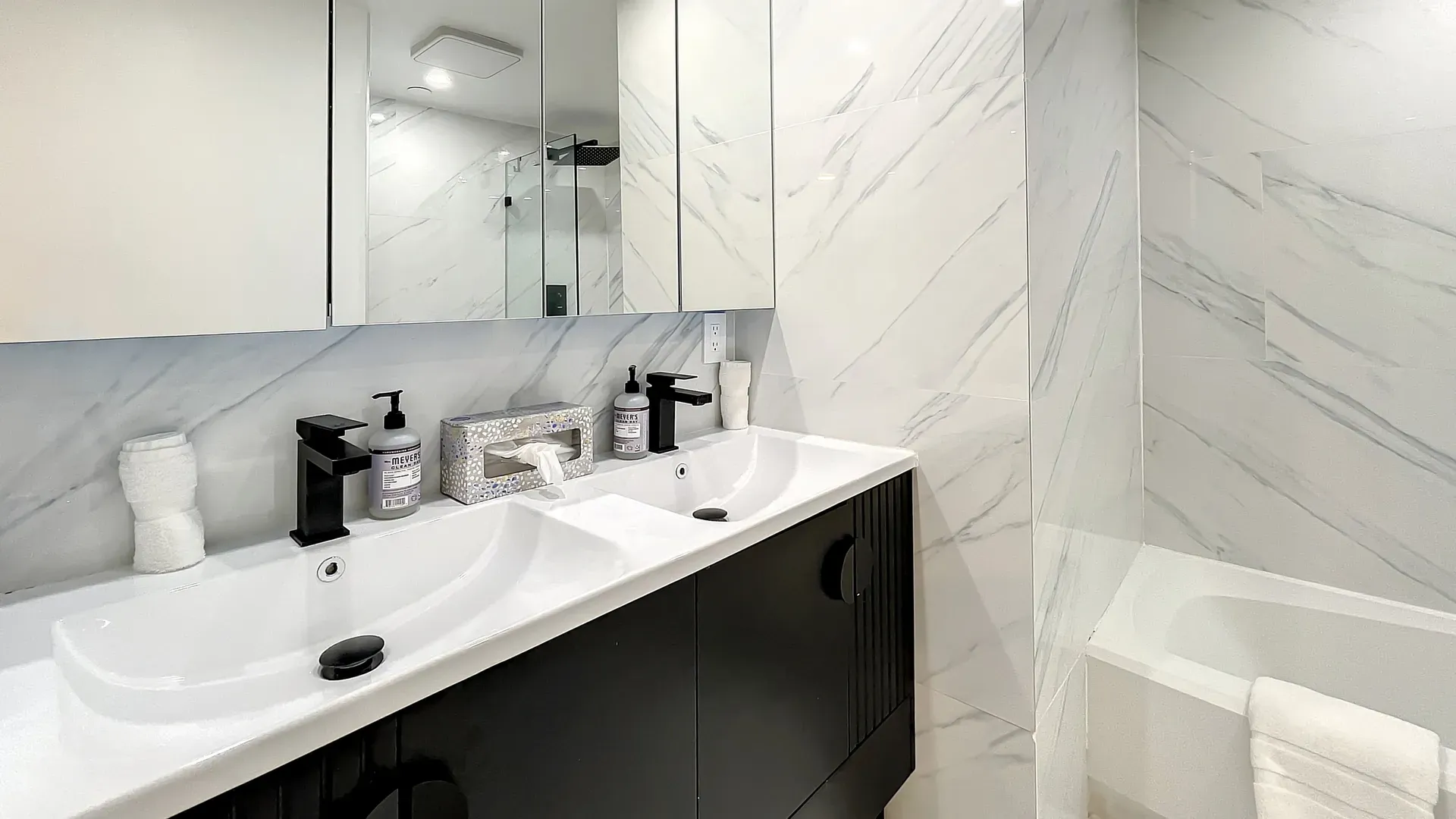 Double mirror wall cabinets offer ample storage space for guests to store their toiletries and personal items, helping to keep the bathroom organized and clutter-free. 