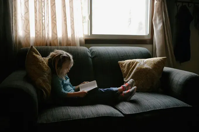 little girl reading a personalized children's book