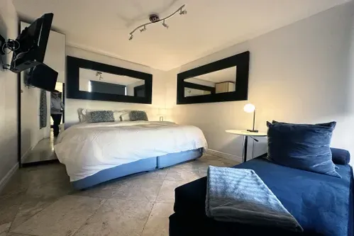 Bedroom with 1 King or 2 Twin Beds, 24-inch Smart TV, and closet.