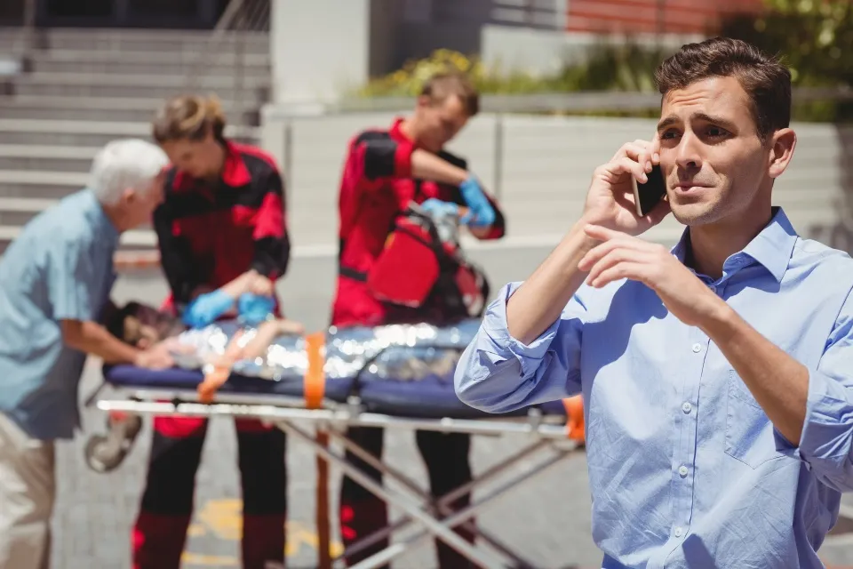 Man on phone calling for urgent healthcare