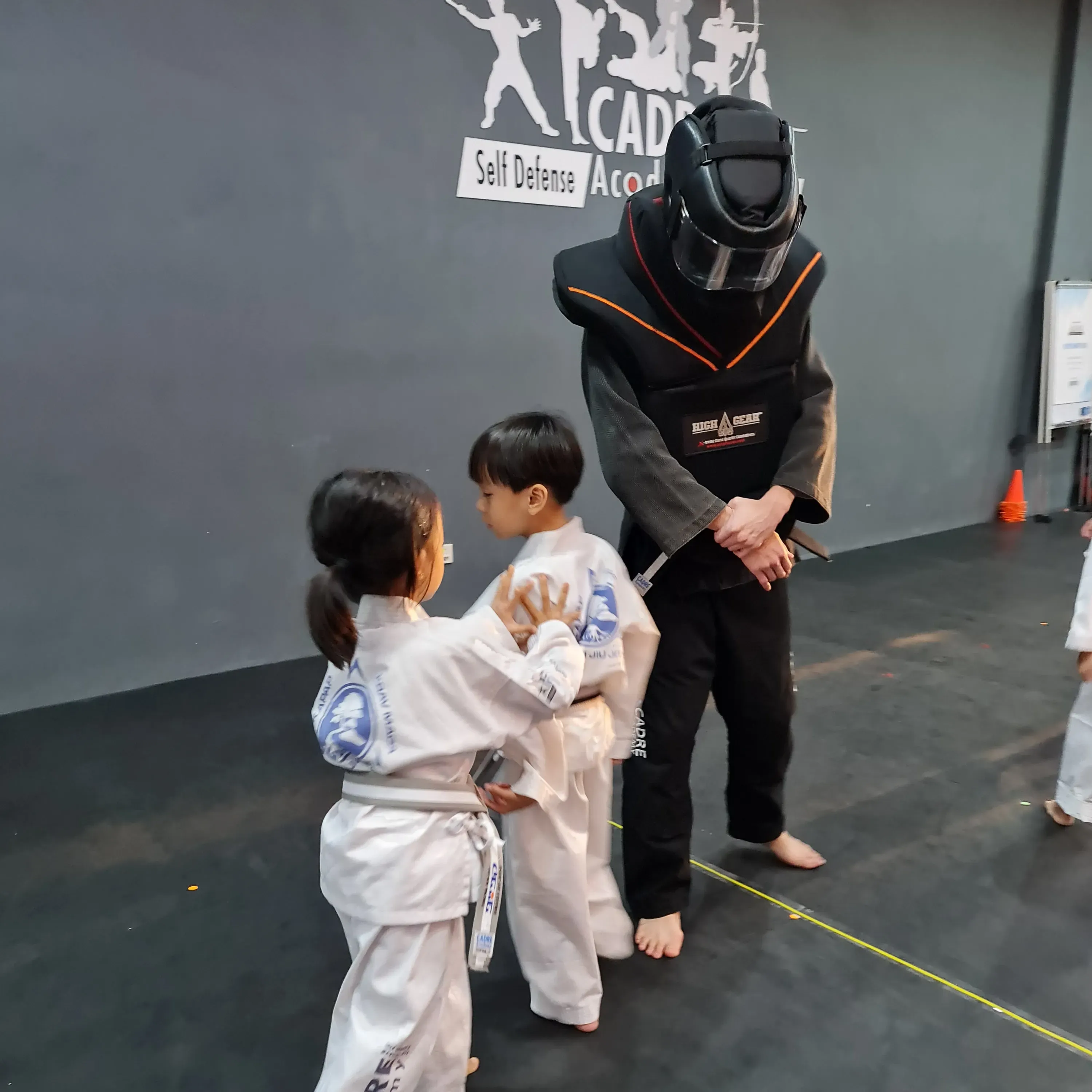 Children adapting their Integrated Jiujitsu skills during scenario-based training at CADRE Academy.