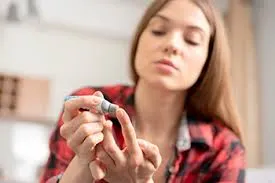 woman testing blood sugar