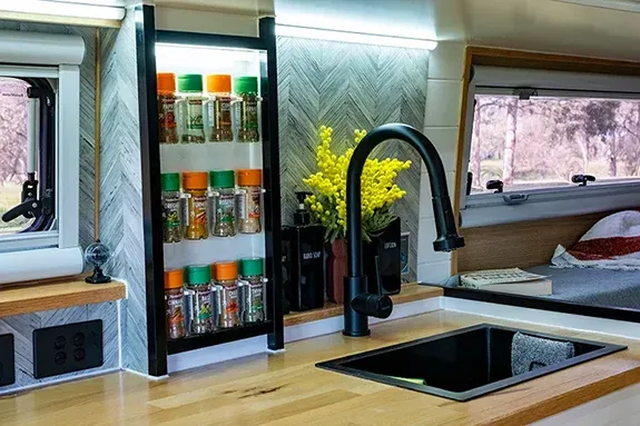 Campervan kitchen sink and plumbing supplied by 180L fresh water and 48L grey water tanks with Cerbo GX monitoring