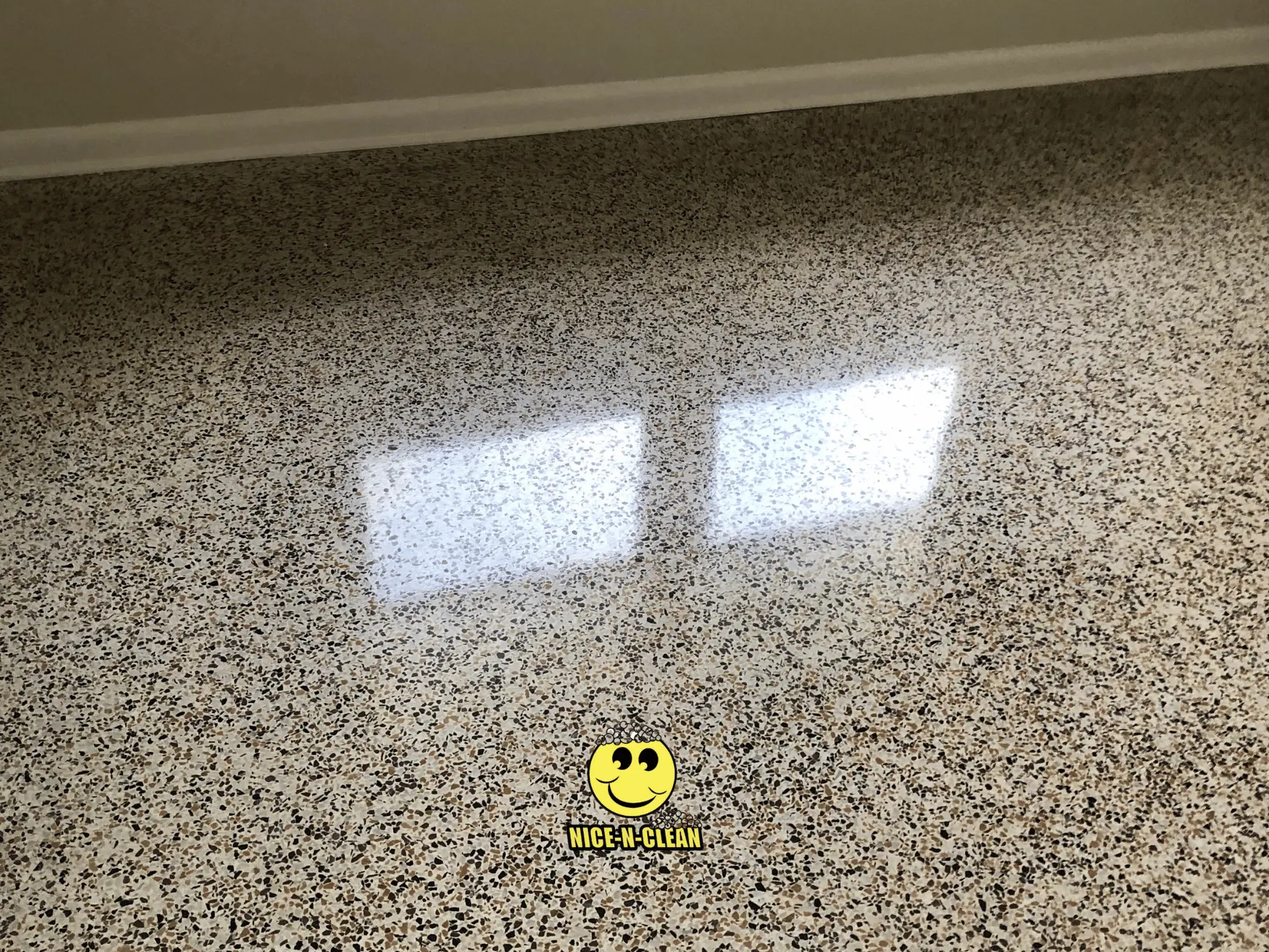 Very shiny brown terrazzo after being cleaned, sealed, and polished.