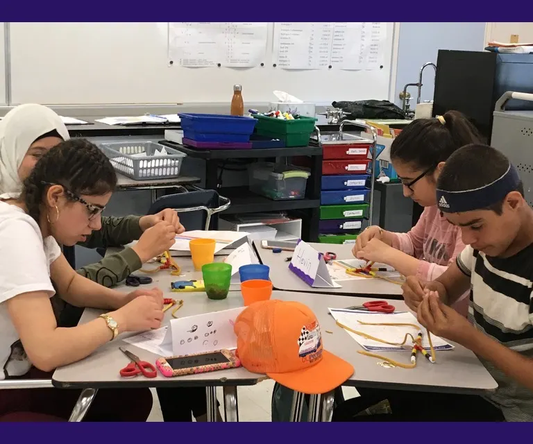high school students learning to bead