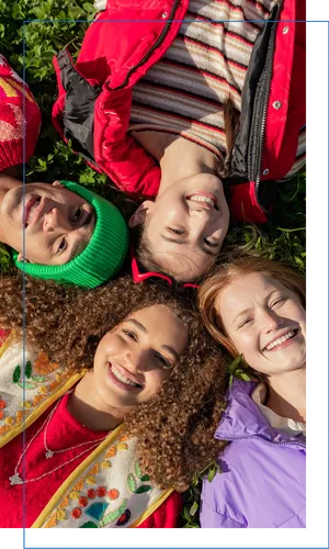 Four teenage girls lying in the grass