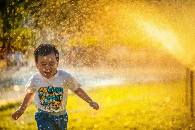 little boy happy playing in the garden