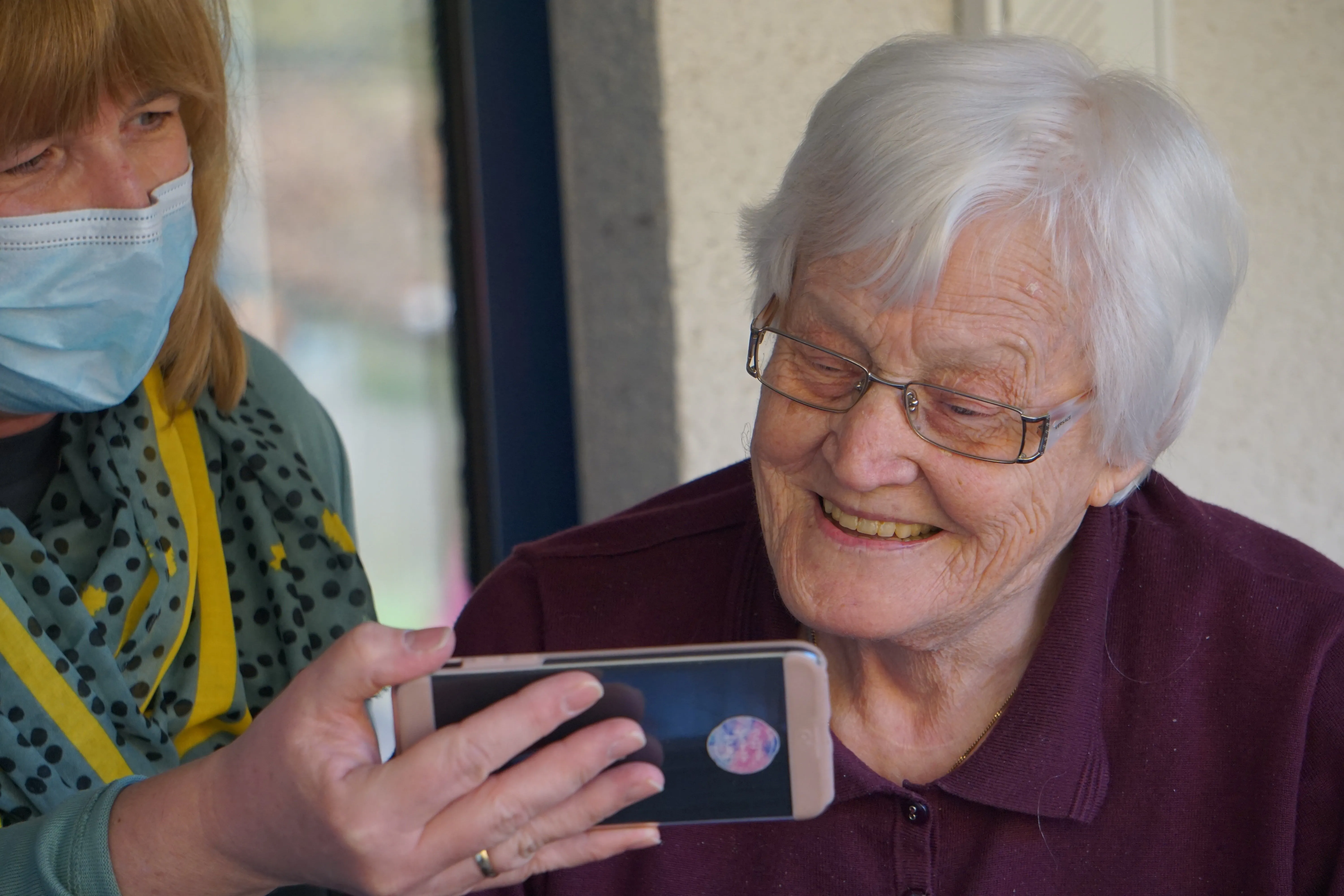Happy Senior lady looking at phone screen