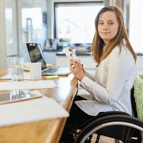 young woman in wheelchair on computer