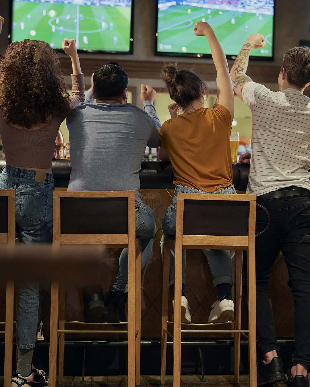 Game Day Entrepreneurs cheering while watching a football game at a pub
