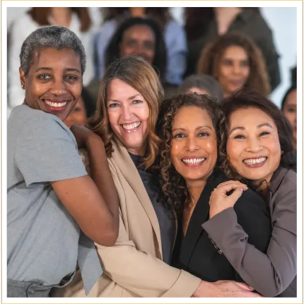 Group of women lined up together hugging each other and smiling