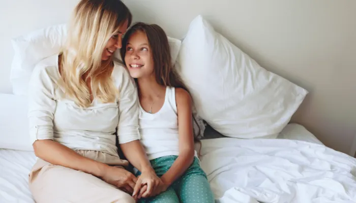 Mom and daughter smiling together.