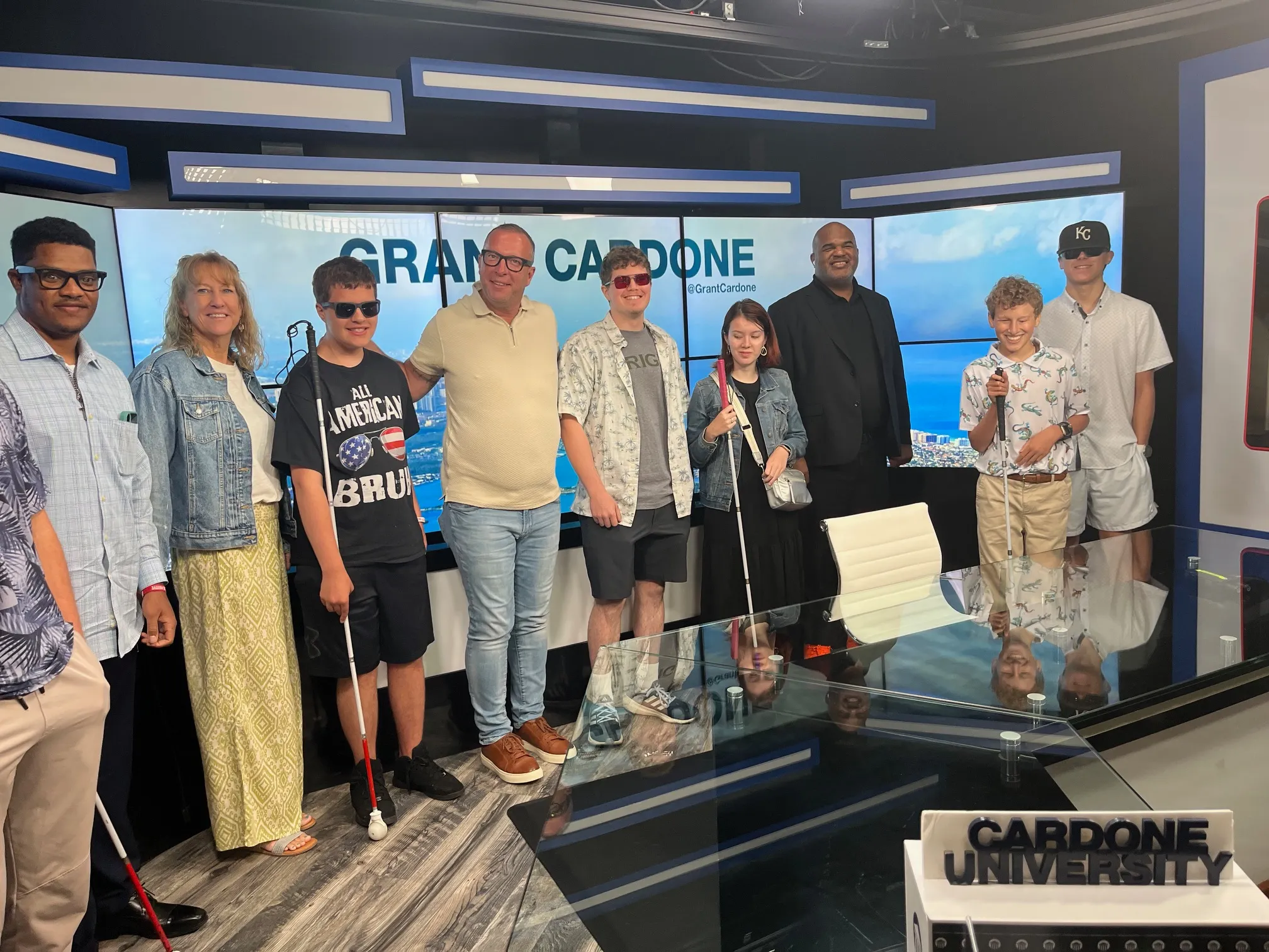 adults and young folks standing together in a studio smiling