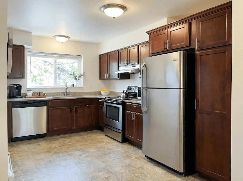 <alt=“Updated full kitchen inside AHA Global Holdings furnished corporate apartment in Ann Arbor, with stainless steel appliances, modern cabinets, and bright natural lighting.”>