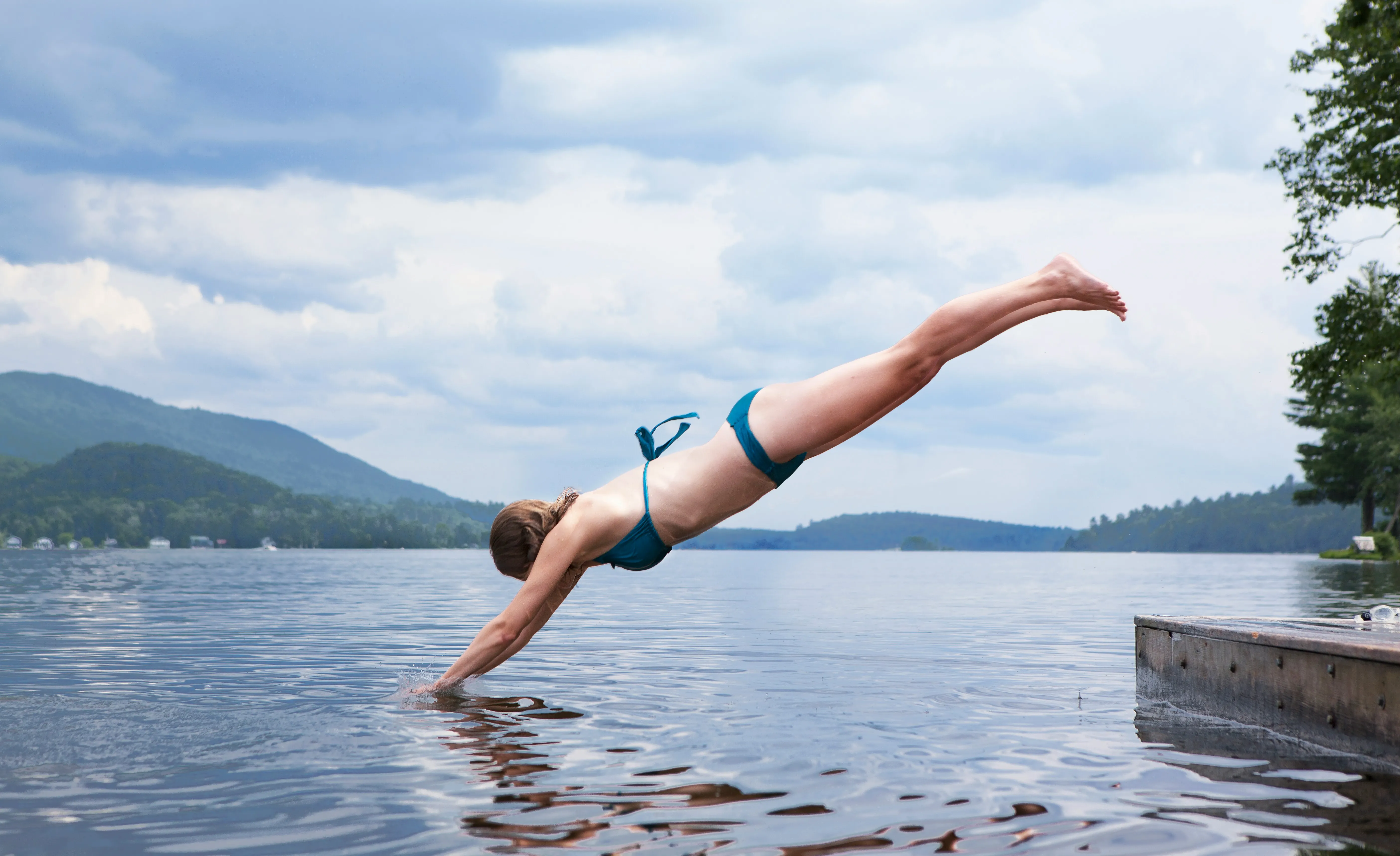 Woman diving into lake in the summer