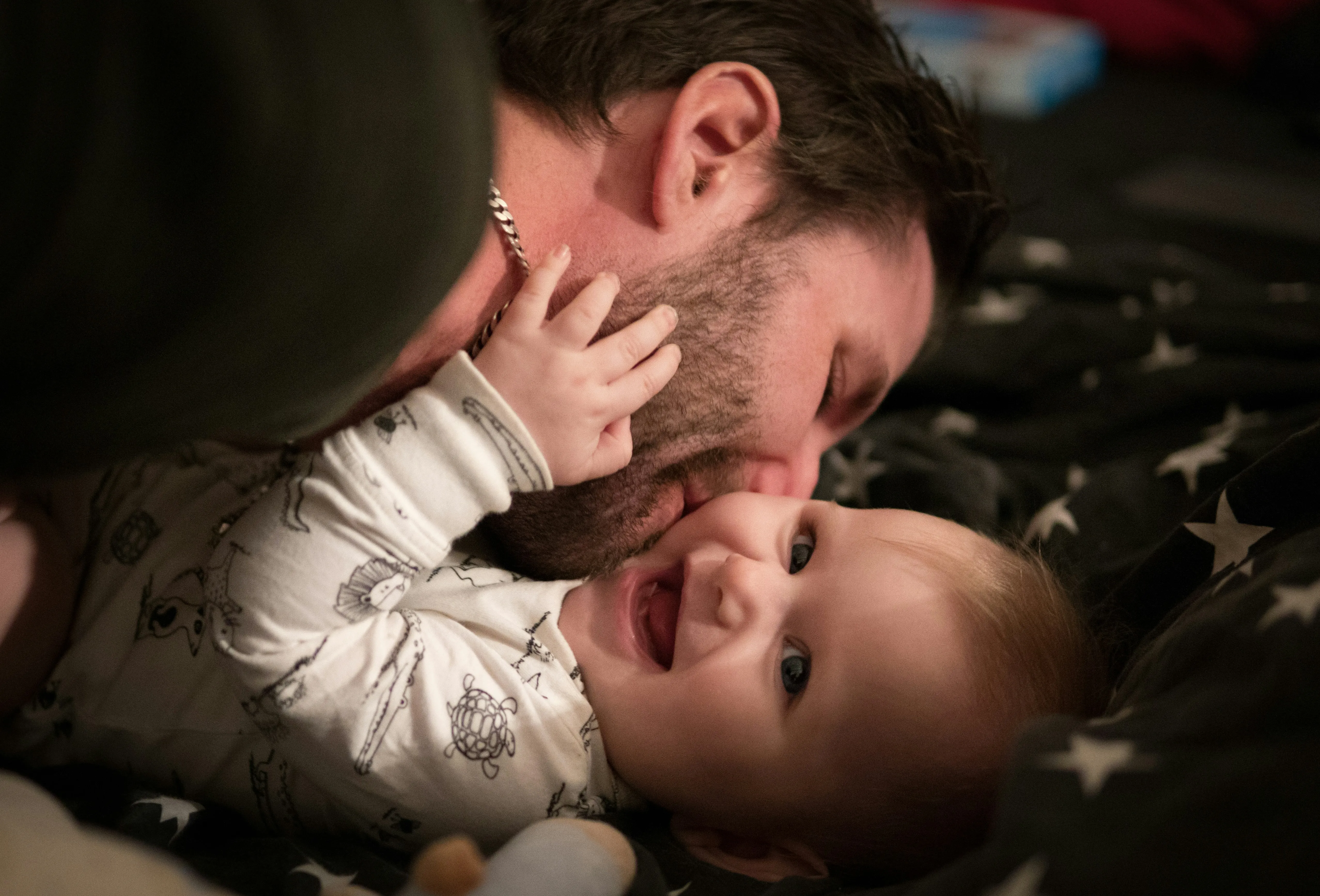 father kissing his baby