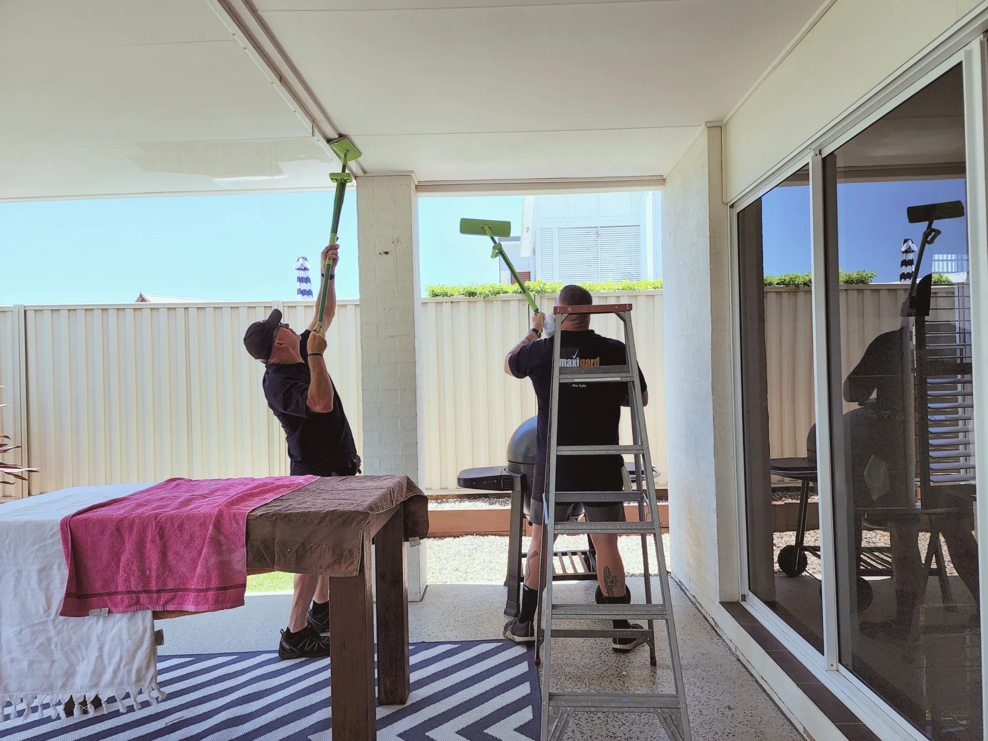 men-cleaning-outdoor-entertaining-space