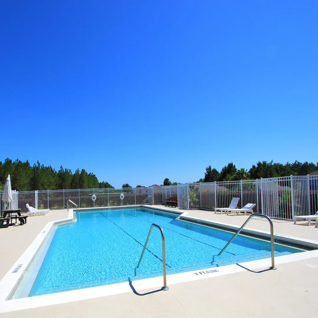 sun loungers or seating areas surrounding the pool