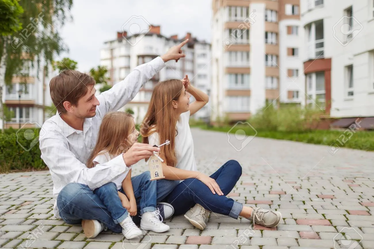 Young family pointing excitedly to their newly purchased apartment unit