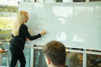 The Life Coaching Co Founder writes on a whiteboard