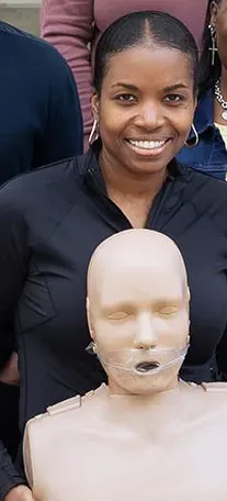 CPR Student Holding CPR Manikin