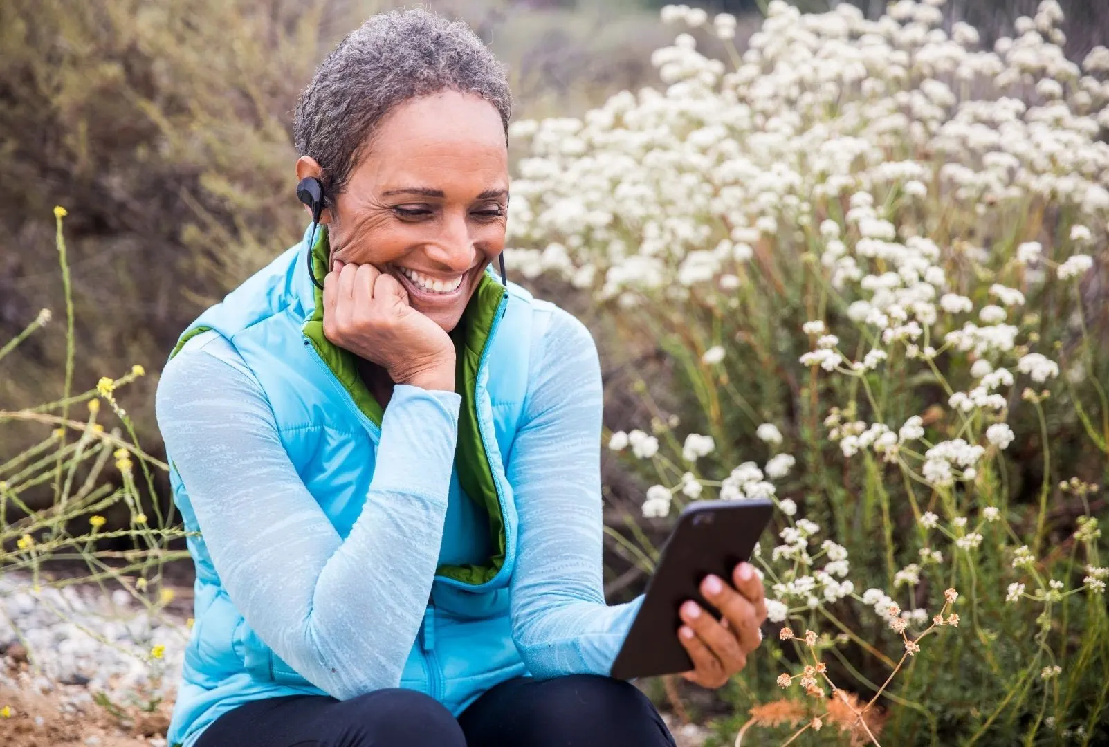 Senior woman listening to podcast