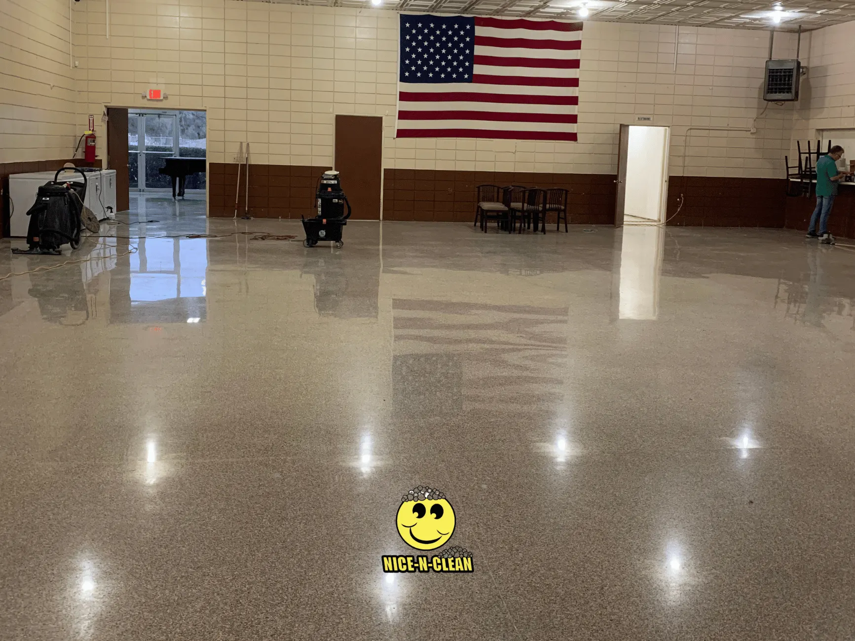 Very shiny and clean terrazzo in a gym with an American flag.