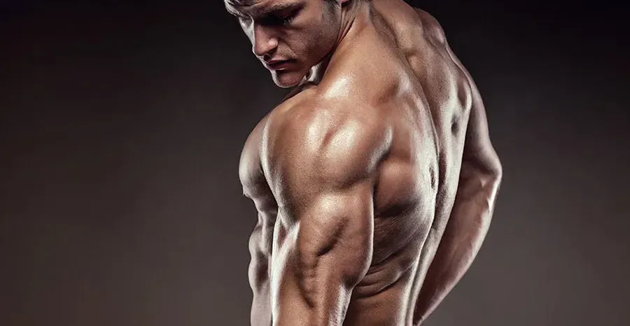 A man flexing his triceps muscles. 