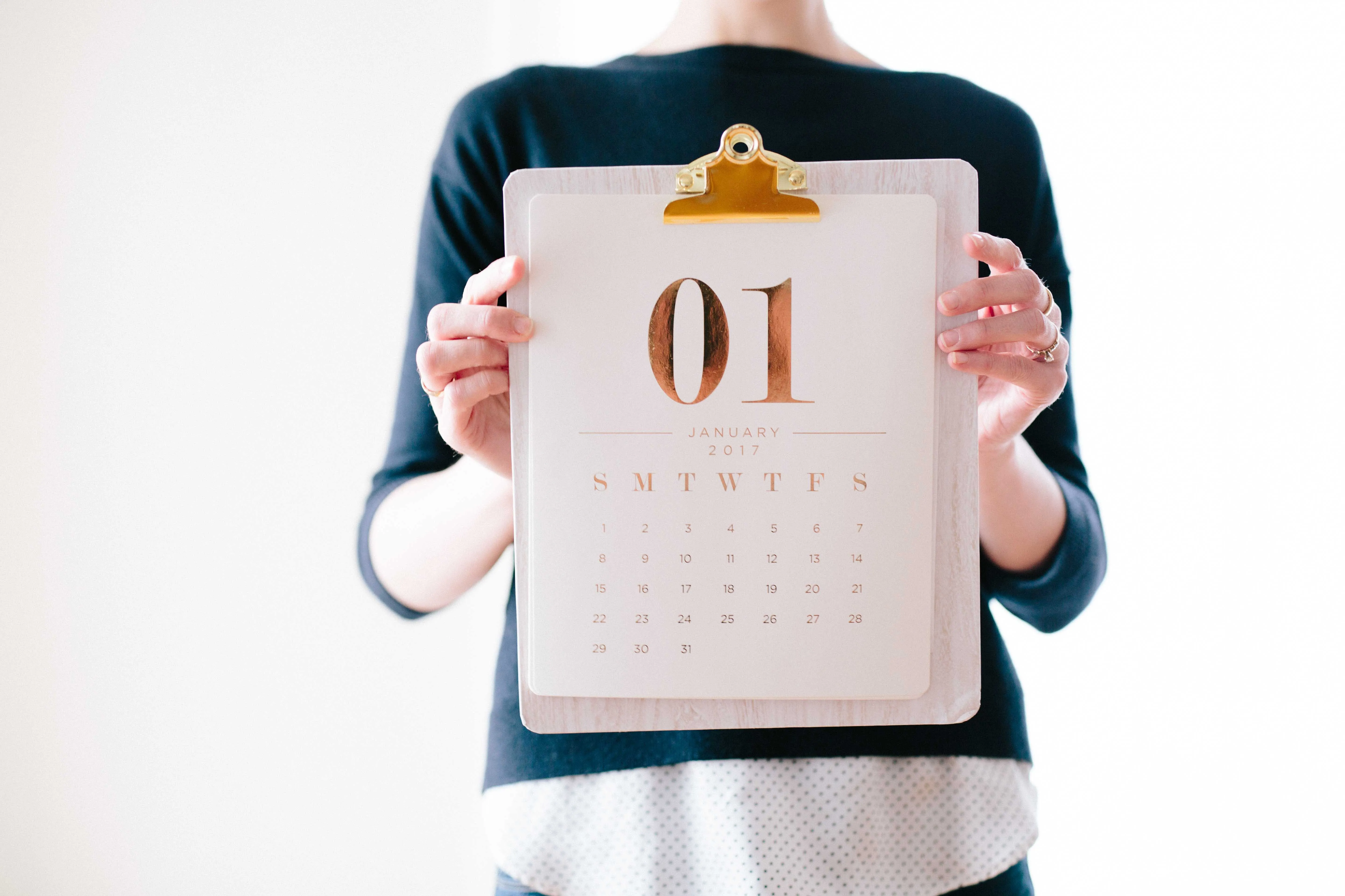 woman in Tucson luxury apartment holding daily trash removal calendar